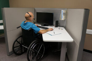 A male employee with a disability in his workplace