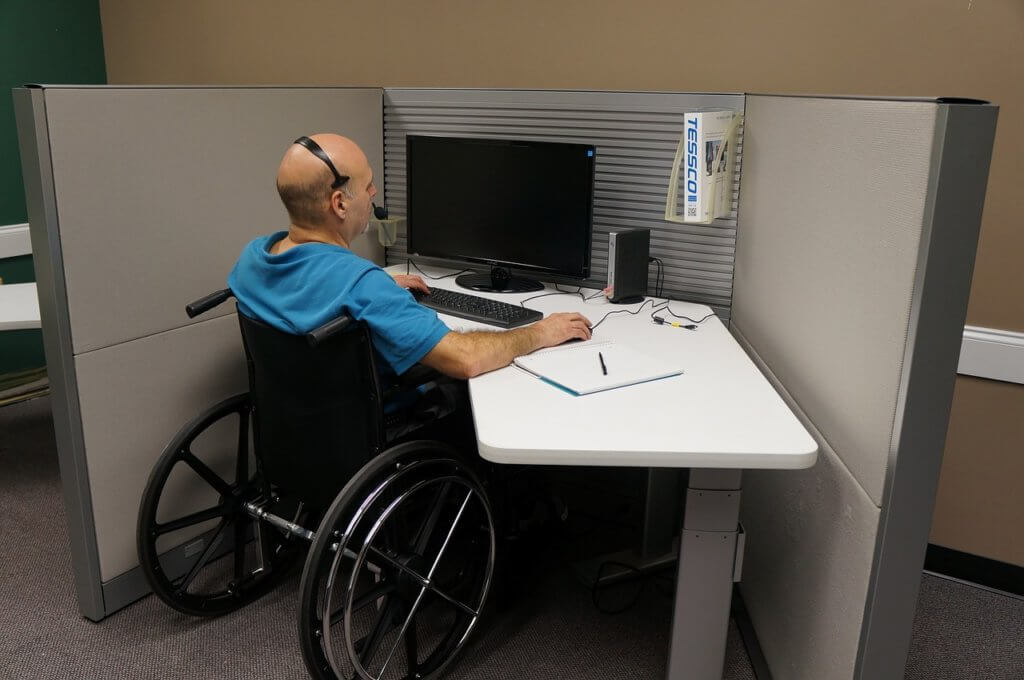 A male employee with a disability in his workplace