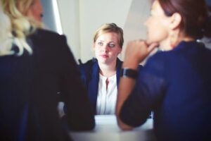 A woman experiencing hiring discrimination during an interview