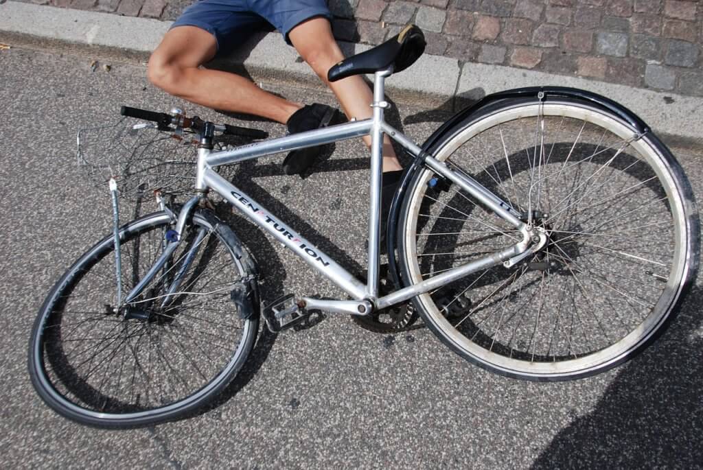Cyclist on the ground after a bicycle accident