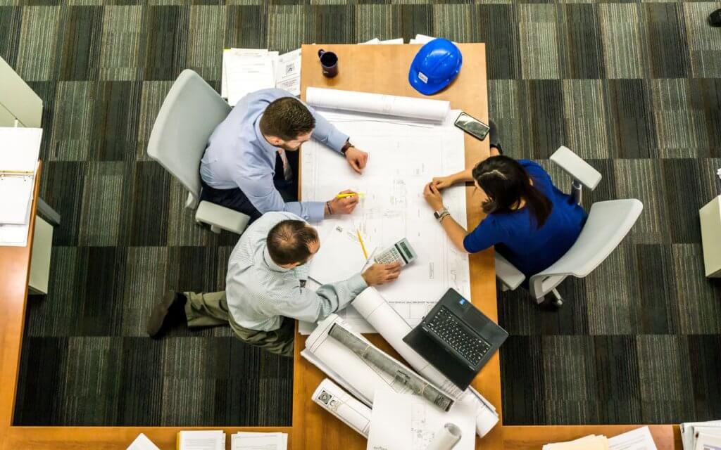 Workers at an architectural firm creating a blueprint
