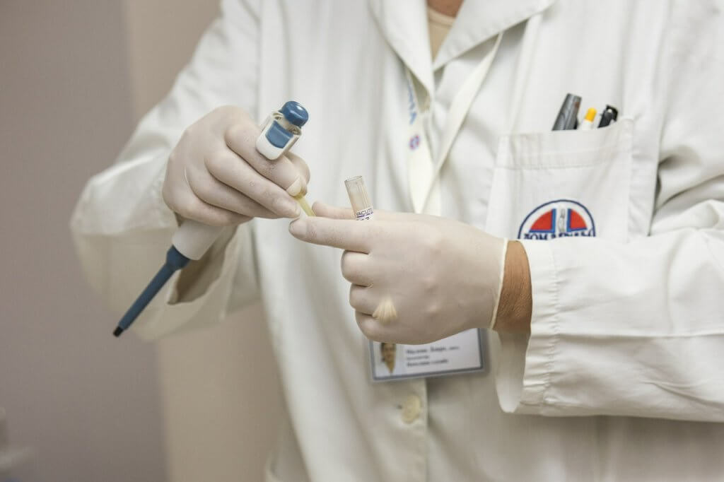 Doctor putting medication in a syringe