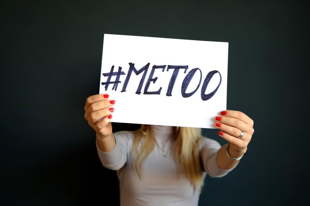 Blonde woman holding up a me-too sign