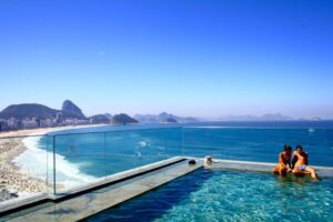 A couple chatting on the side of pool