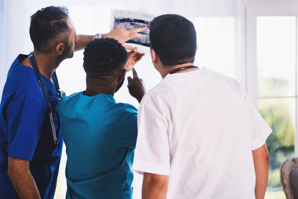 Three doctors looking at an X-ray result