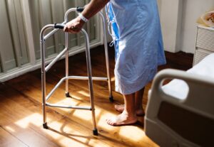 a patient using a walker after a physical therapy malpractice