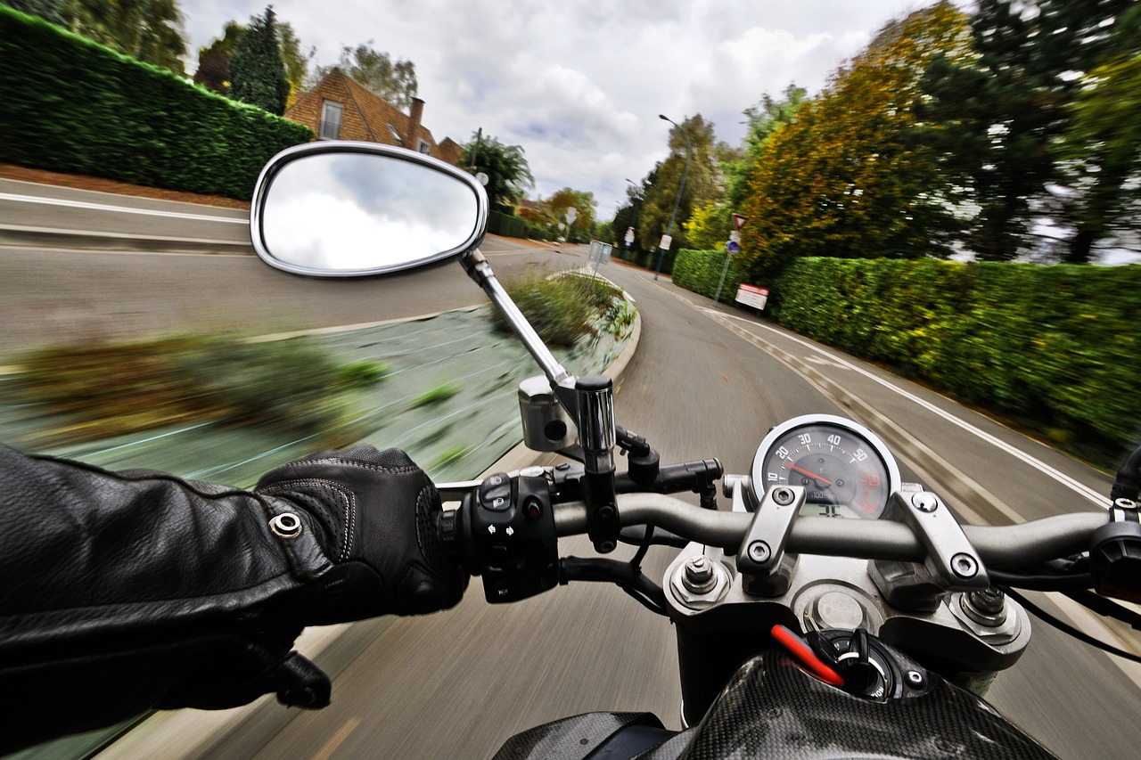 POV Riding motorcycle fast on the road with gloves