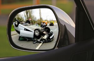 toppled down car in side mirror
