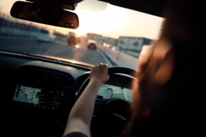 Woman driving a car with GPS navigation