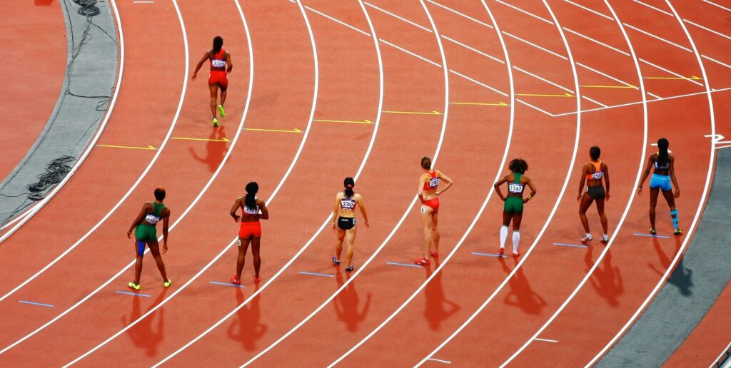 female athletes running on a race track