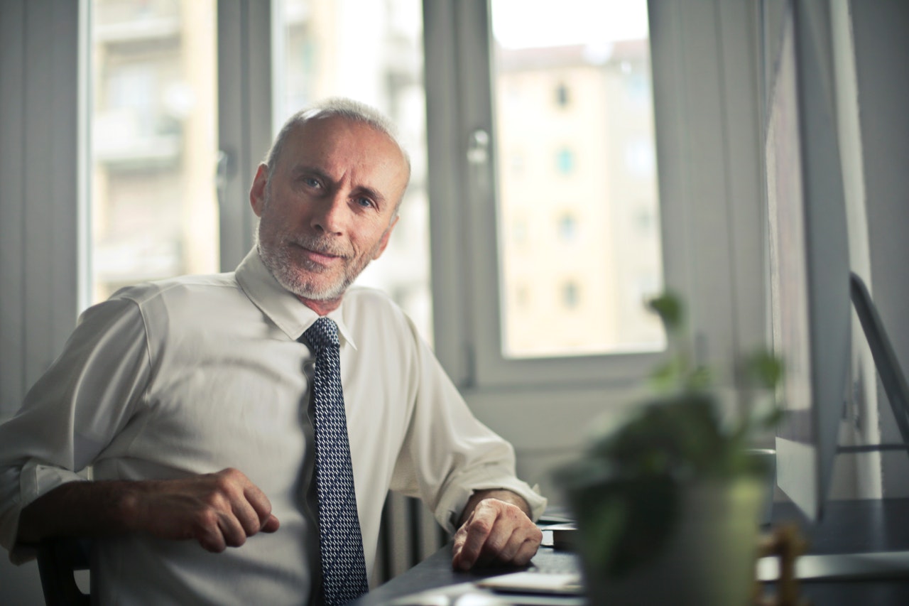 old man in a suit in the office